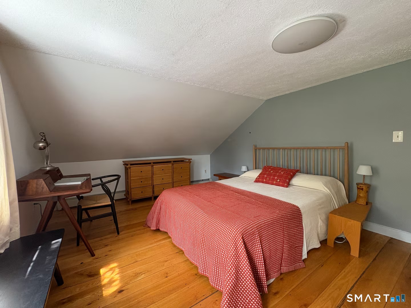 895 Tolland Stage Road Tolland, CT 06084 - Photo 20 of 33 a bedroom with a bed a lamp and a desk
