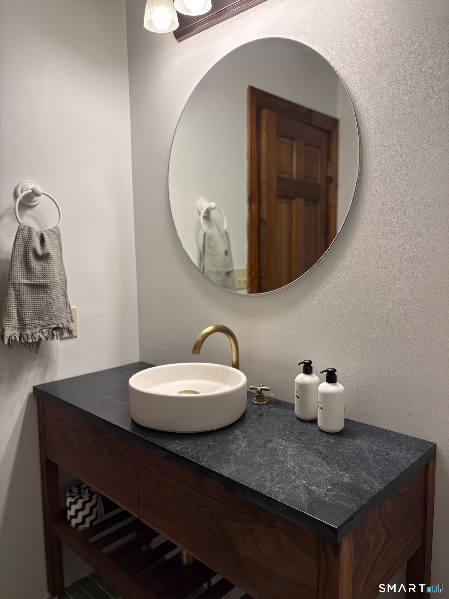 895 Tolland Stage Road Tolland, CT 06084 - Photo 23 of 33 a bathroom with a sink a mirror and toilet