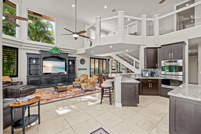 a bedroom with furniture and a large window