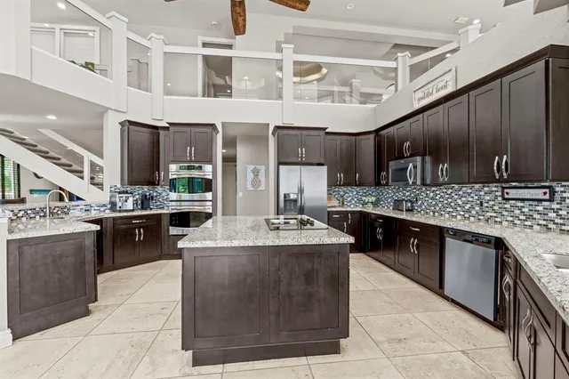 a bedroom with a bed dresser flowerpot and window