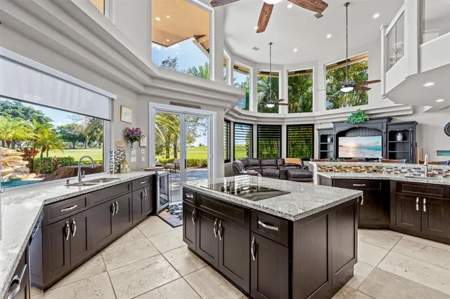 a bathroom with a granite countertop sink a toilet and bathtub