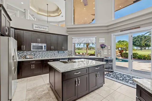 a spacious bathroom with a granite countertop sink mirror and a bathtub