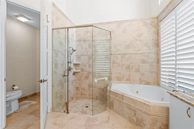 a spacious bedroom with a bed and a window