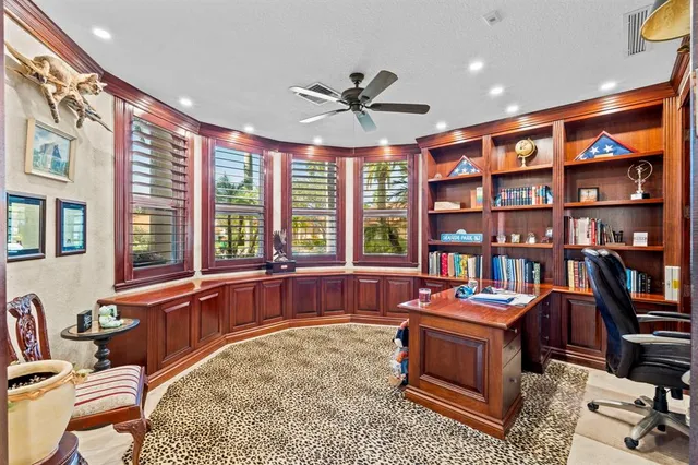 a spacious bedroom with a bed a chandelier and couch