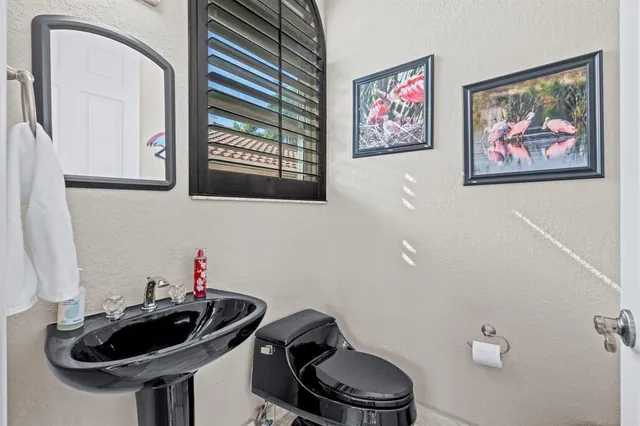 a spacious bedroom with a bed a dresser and large window