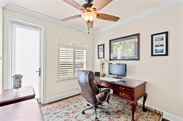 a bedroom with a bed and a flat tv screen on the dresser
