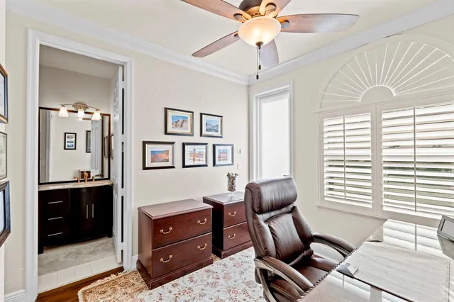 a view of a patio with table and chairs potted plants and floor to ceiling window
