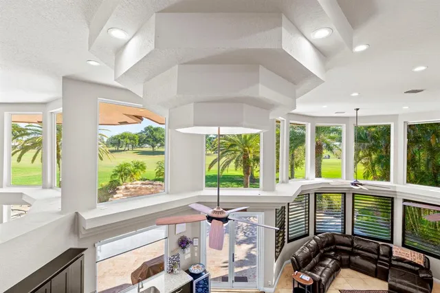 a view of a swimming pool with a lounge chairs and a yard