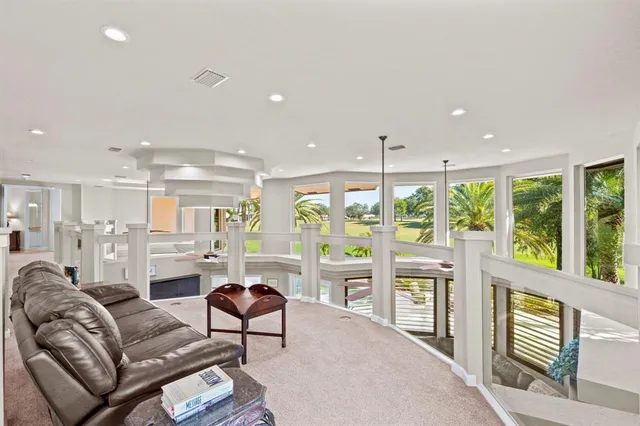 a view of a backyard with swimming pool and sitting area