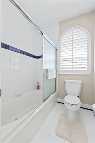 an aerial view of residential houses with outdoor space and ocean view