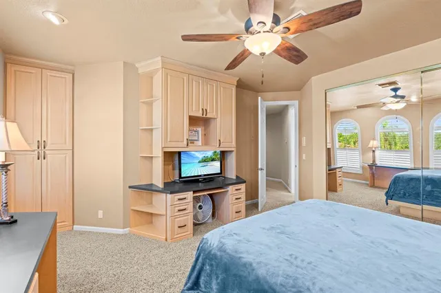 an aerial view of residential houses with outdoor space and swimming pool