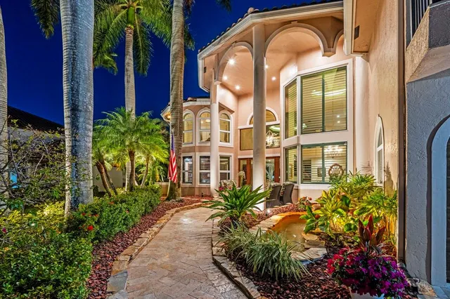 a living room with furniture a floor to ceiling window and a fireplace