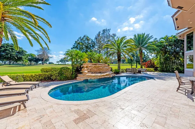 a view of yard with swimming pool and green space