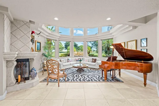 a room with furniture a large window and a chandelier