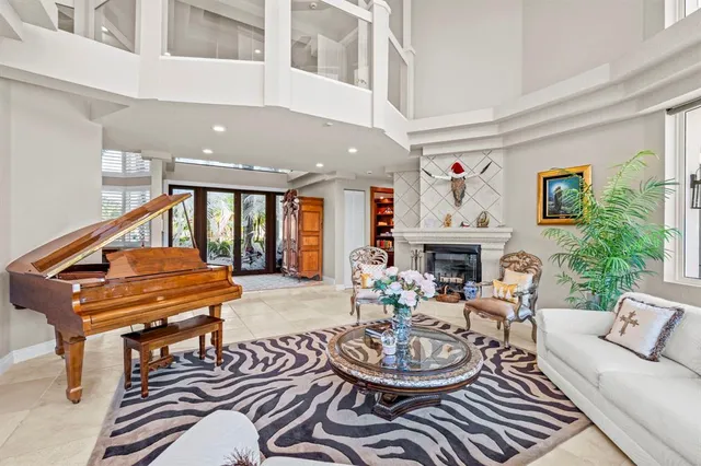 a kitchen with a stove a chandelier and chairs