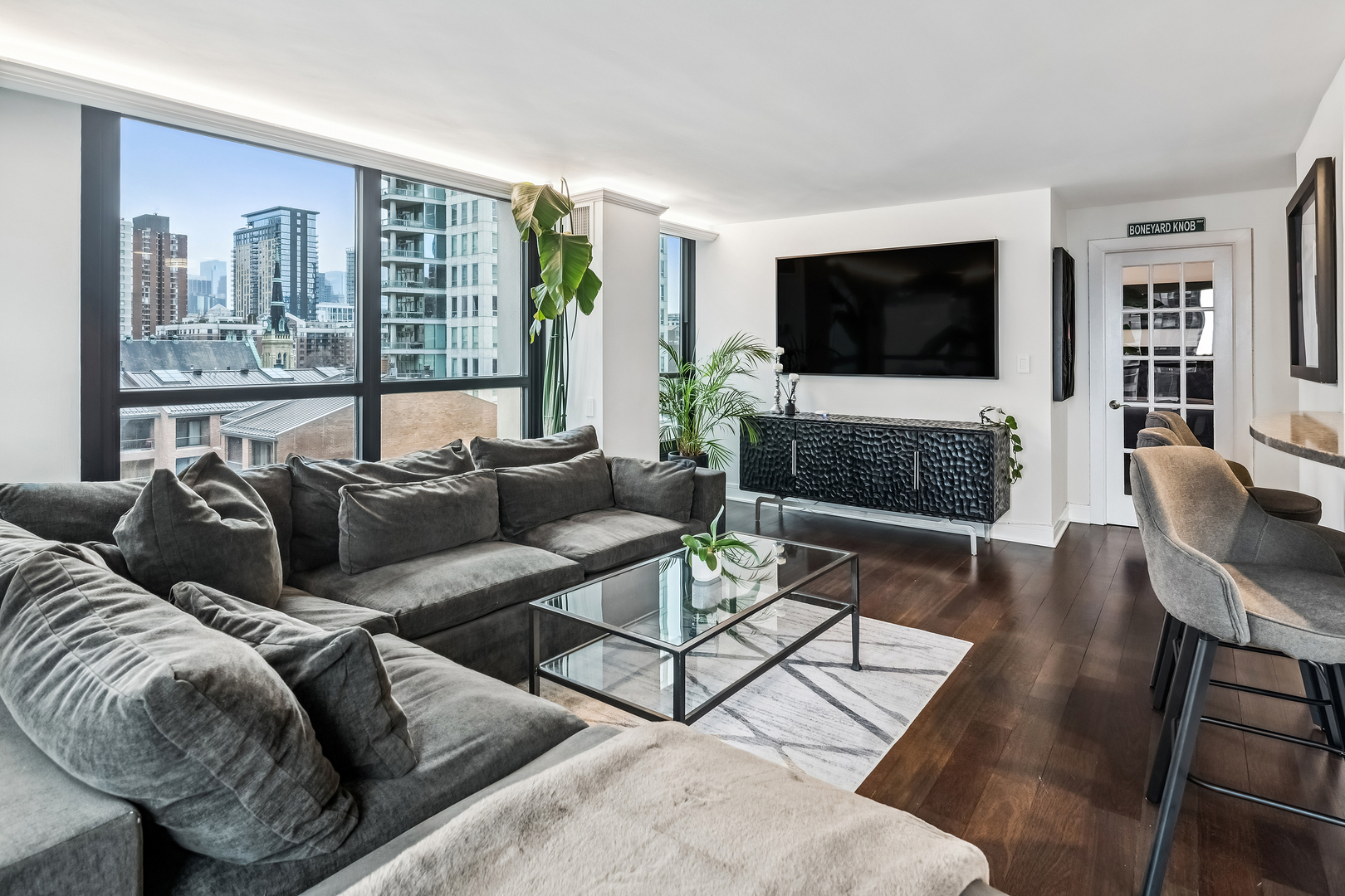1030 North State Street, Unit 2GH Chicago, IL 60610 - Photo 11 of 36 a living room with furniture a flat screen tv and a large window