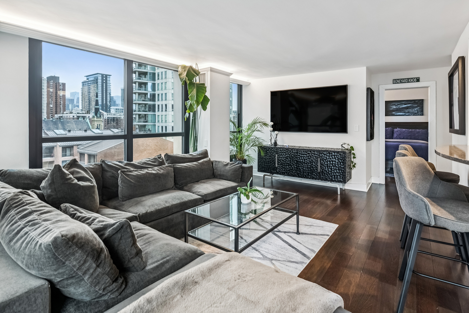 1030 North State Street, Unit 2GH Chicago, IL 60610 - Photo 12 of 36 a living room with furniture a flat screen tv and a large window