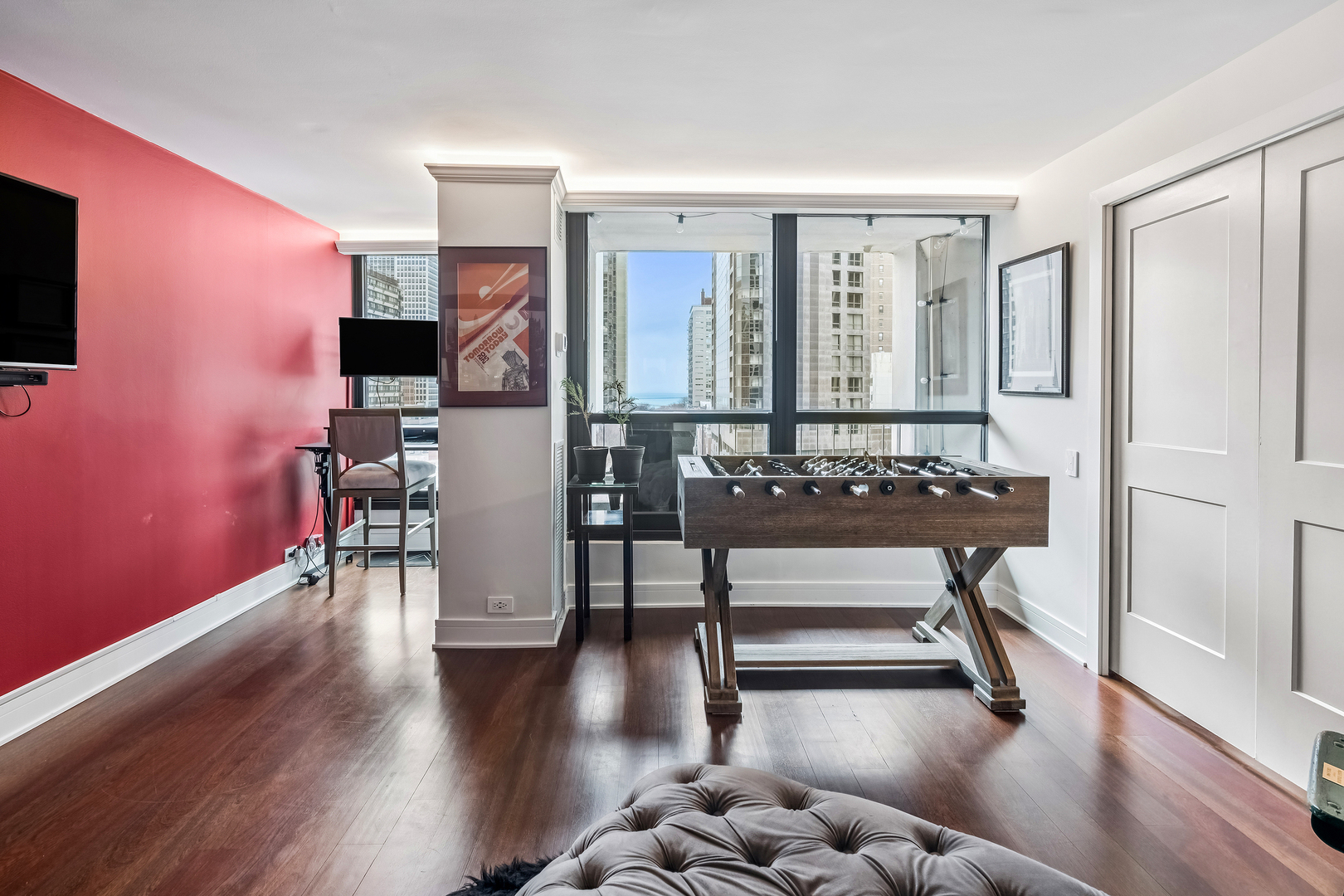 1030 North State Street, Unit 2GH Chicago, IL 60610 - Photo 14 of 36 a living room with furniture a wooden floor and a flat screen tv