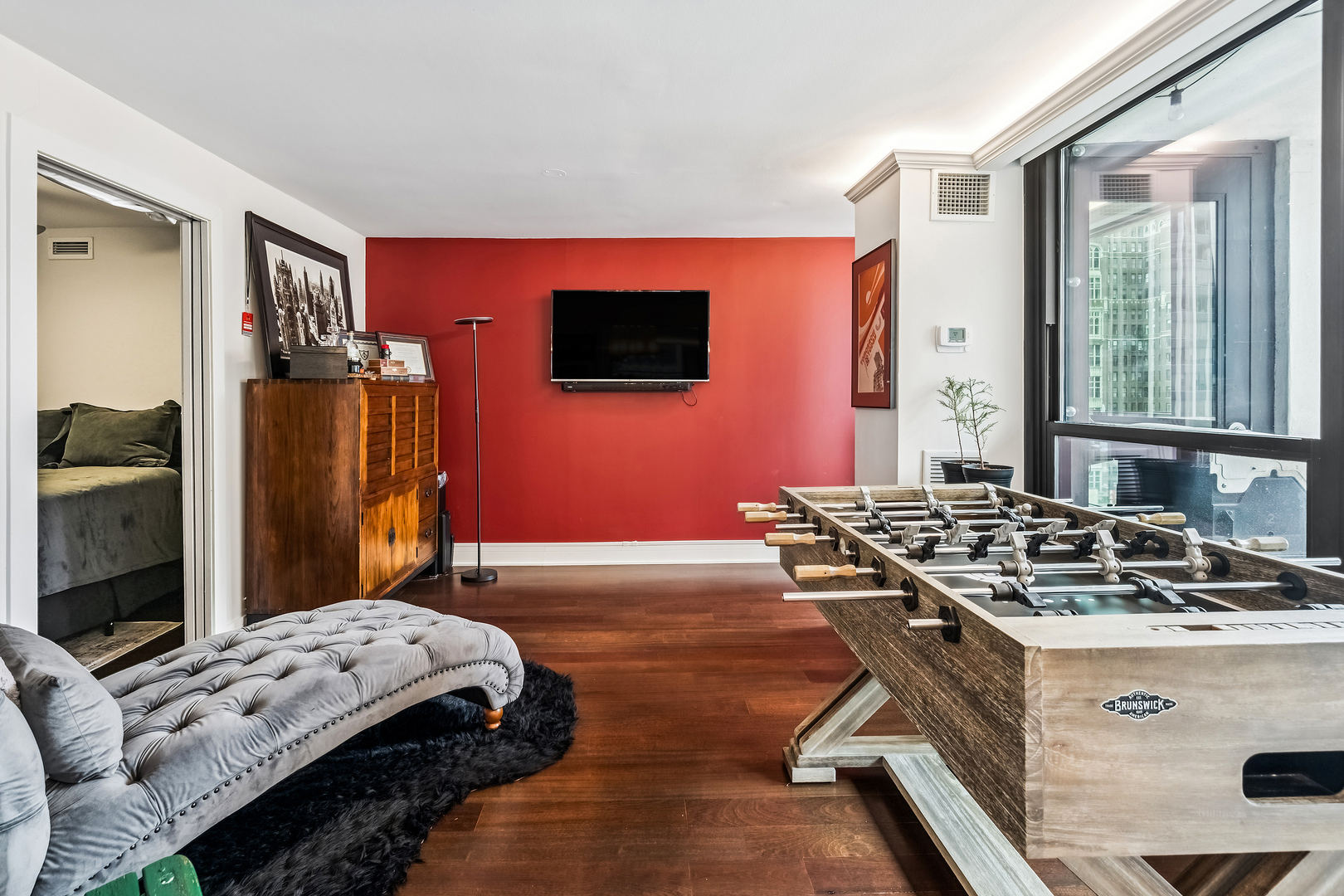 1030 North State Street, Unit 2GH Chicago, IL 60610 - Photo 15 of 36 a bedroom with a bed and a flat screen tv