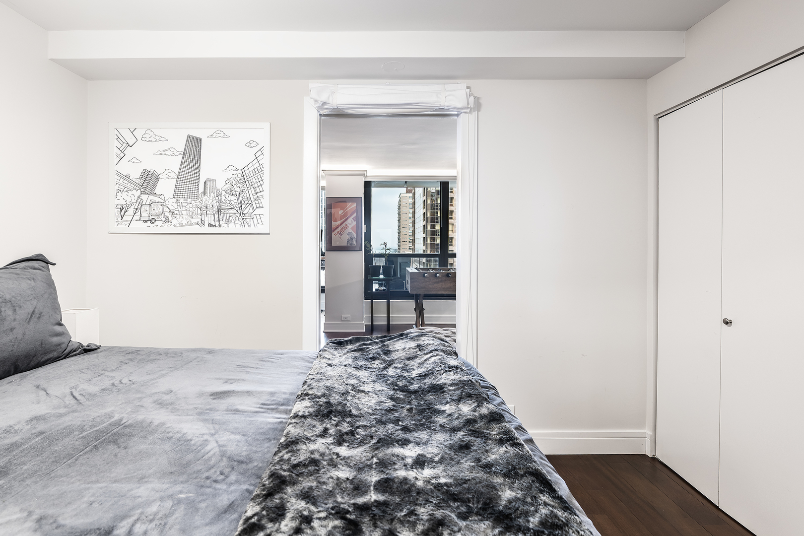 1030 North State Street, Unit 2GH Chicago, IL 60610 - Photo 21 of 36 a view of a hallway to a bedroom with wooden floor and bed