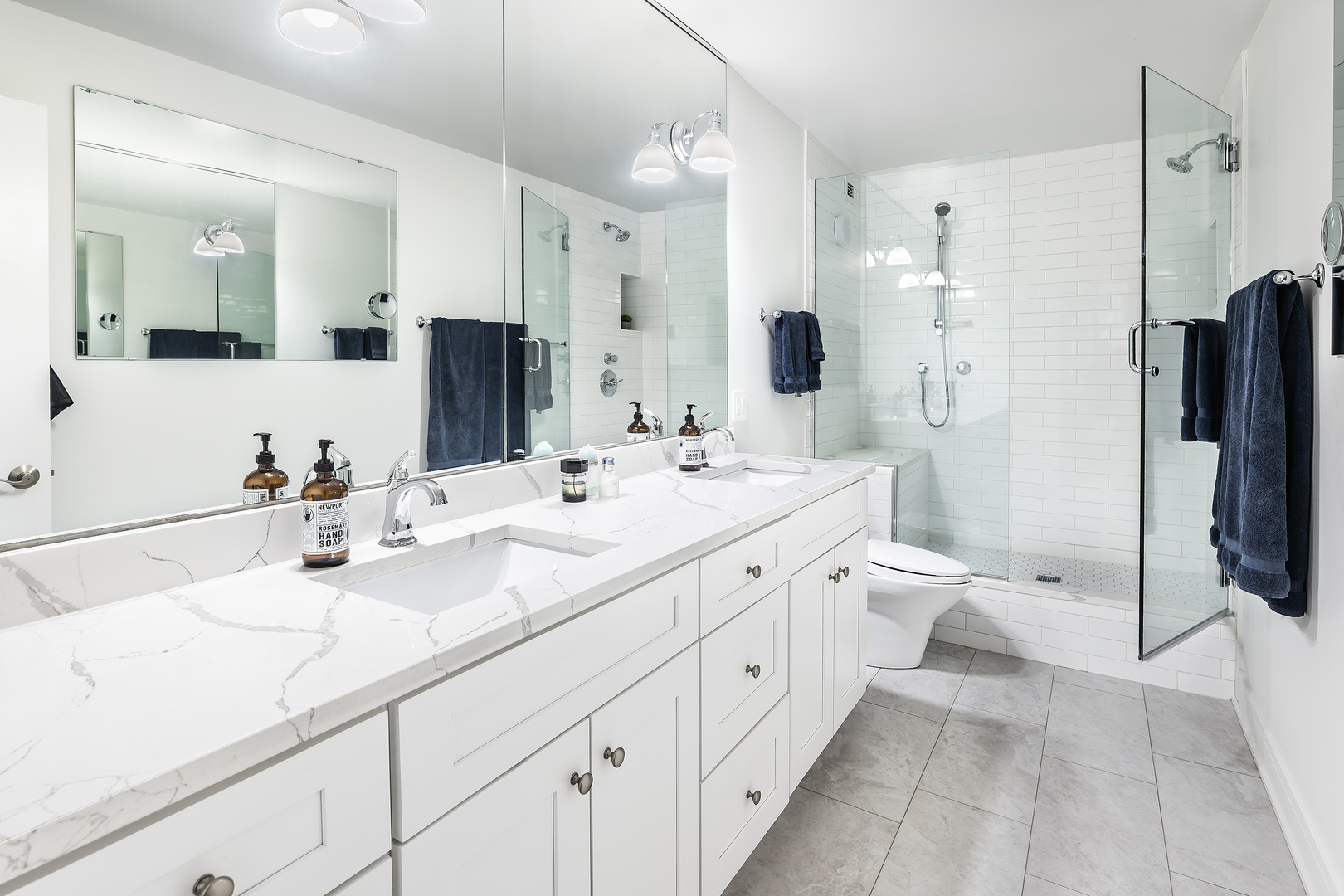1030 North State Street, Unit 2GH Chicago, IL 60610 - Photo 23 of 36 a large bathroom with double vanity sink a large mirror a shower and bathtub