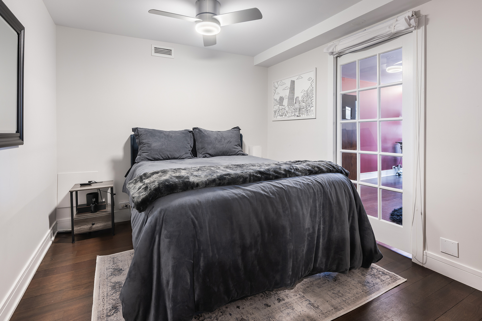 1030 North State Street, Unit 2GH Chicago, IL 60610 - Photo 25 of 36 a bedroom with a bed and wooden floor