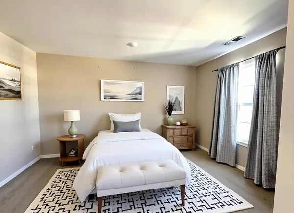 a bedroom with a bed and a large mirror