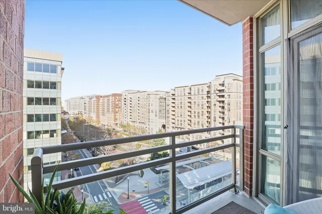 a view of balcony with a large window and wooden fence