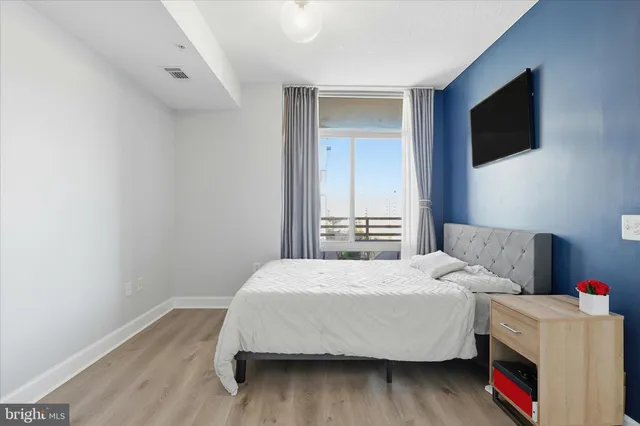 a bedroom with a bed and a flat screen tv