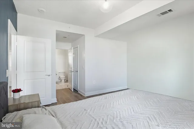 a bedroom with a bed and a couch