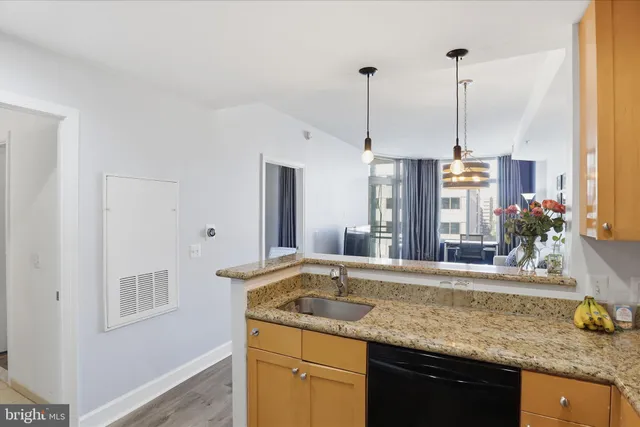 a kitchen with a sink and a counter top space