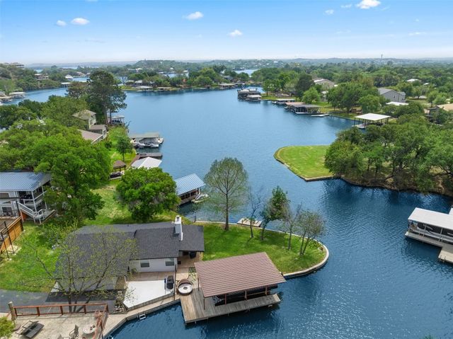 an aerial view of a house with swimming pool and outdoor seating