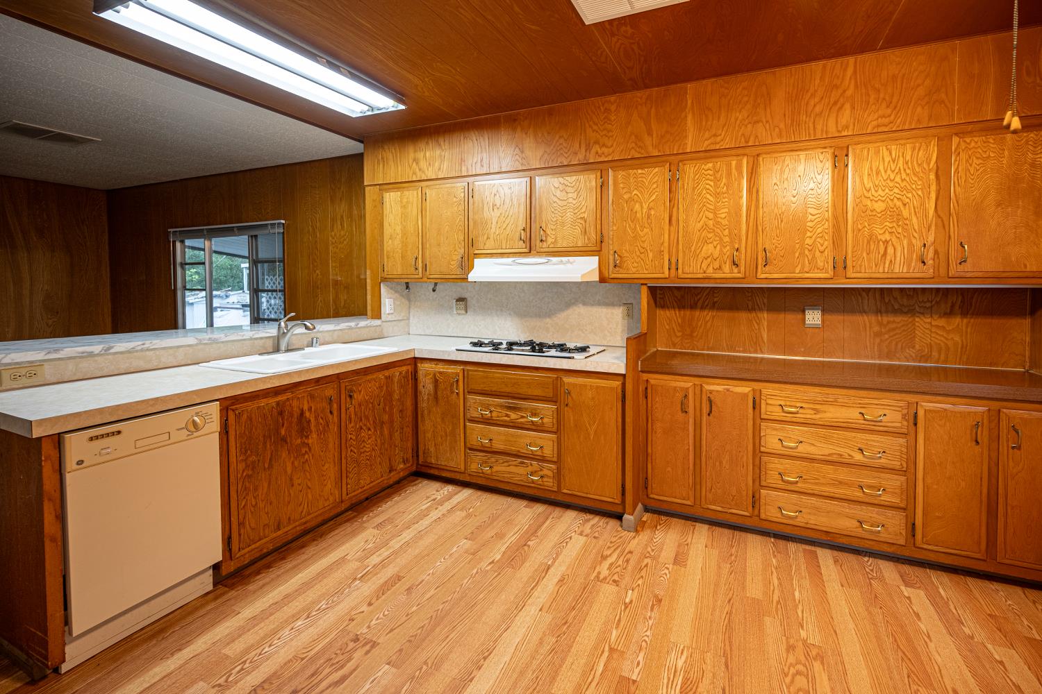 9060 Auburn Folsom Road, Unit 1 Granite Bay, CA 95746 - Photo 12 of 27 a kitchen with stainless steel appliances granite countertop a sink cabinets and wooden floor