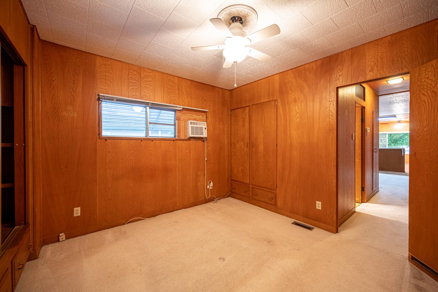 9060 Auburn Folsom Road, Unit 1 Granite Bay, CA 95746 - Photo 18 of 27 a view of a room with a large bed and chandelier fan