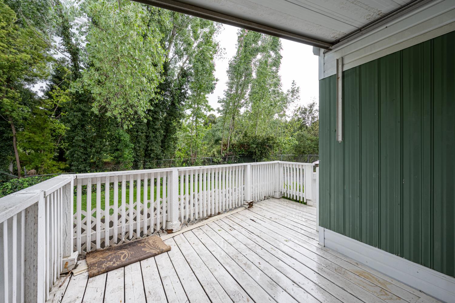 9060 Auburn Folsom Road, Unit 1 Granite Bay, CA 95746 - Photo 22 of 27 a balcony with wooden floor and fence