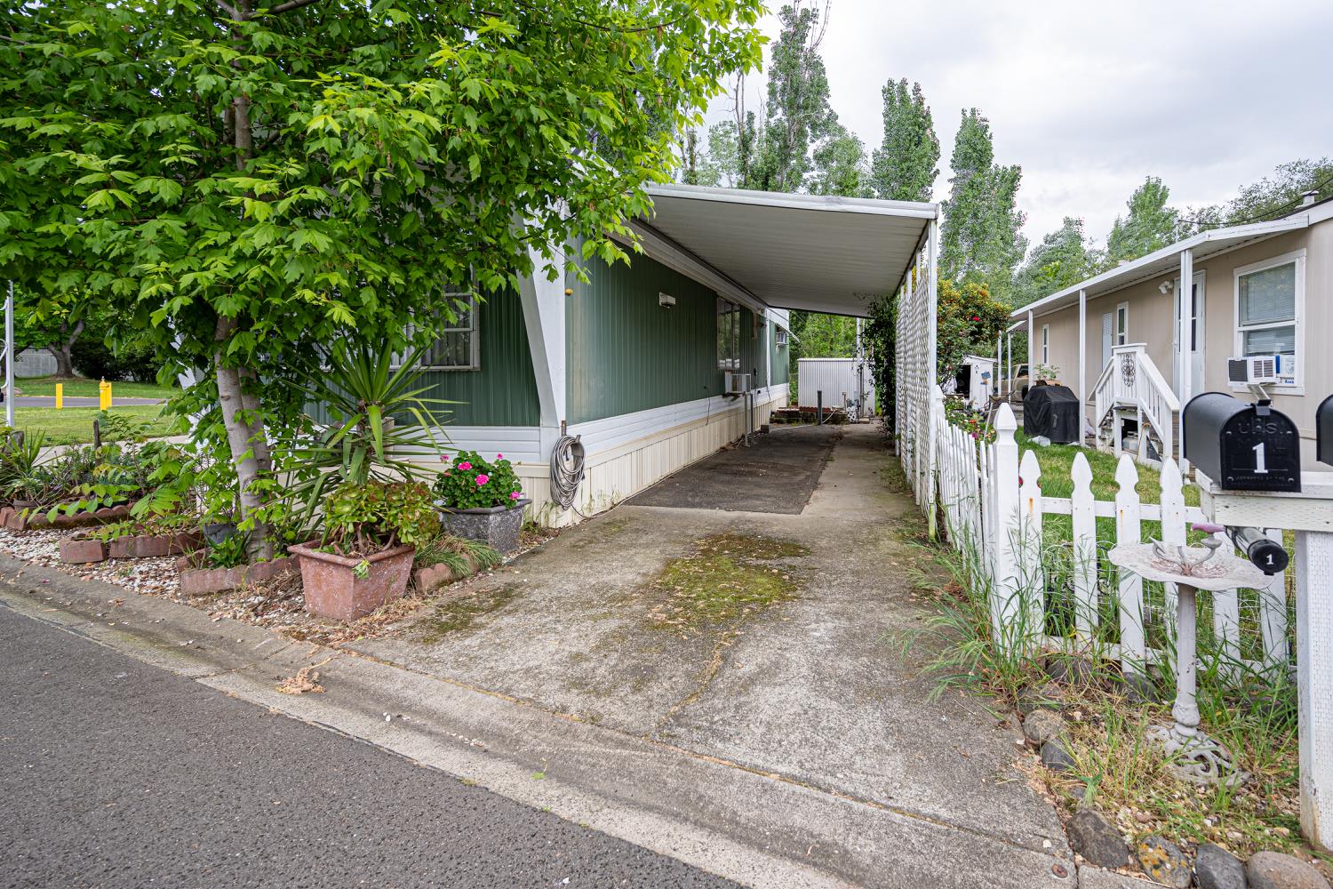 9060 Auburn Folsom Road, Unit 1 Granite Bay, CA 95746 - Photo 5 of 27 a view of a patio with table and chairs potted plants and large tree