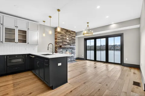 a kitchen with stainless steel appliances granite countertop a sink and wooden cabinets