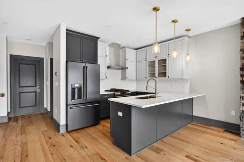 a kitchen with kitchen island a sink appliances and cabinets
