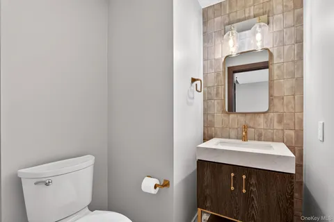 a bathroom with a sink vanity and a toilet