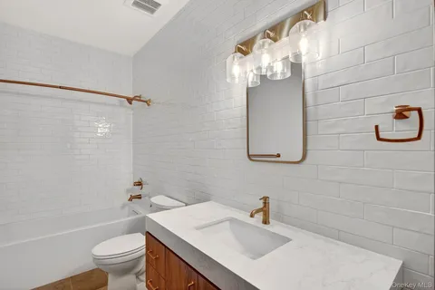 a bathroom with a sink a toilet and shower curtain