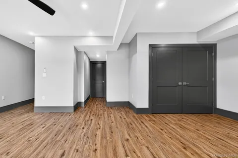 a view of a room with wooden floor and bathroom