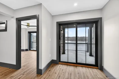 a view of a room with wooden floor