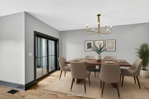 a view of a dining room with furniture and window