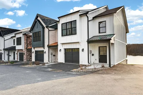 a front view of a house with a road