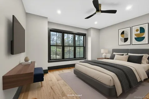 a spacious bedroom with a large bed and a flat screen tv