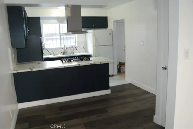 a kitchen with stainless steel appliances a refrigerator and a stove