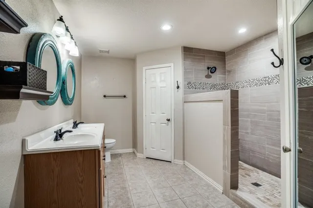 a spacious bedroom with a bed and a chandelier