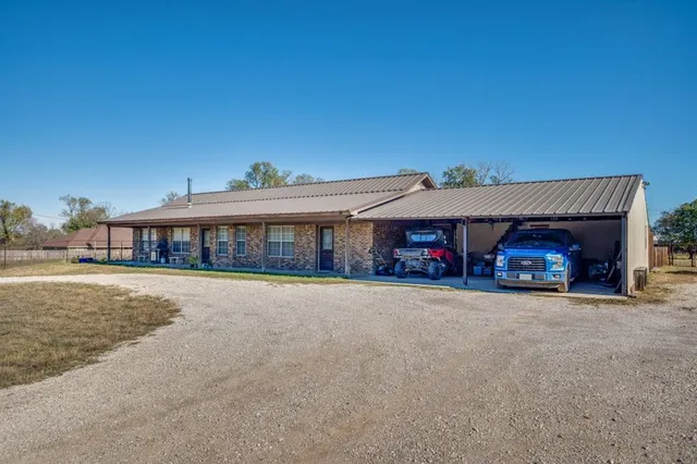 a front view of a house with a garden and balcony