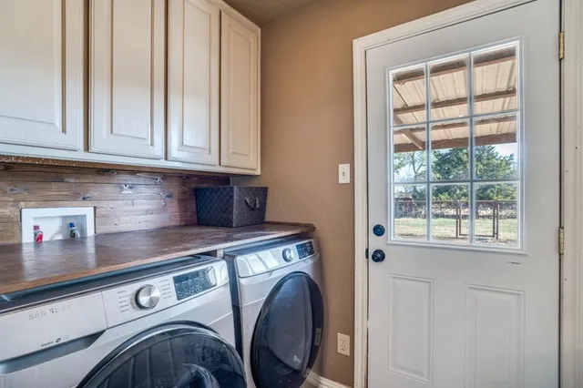 a view of washer and dryer with kitchen in the background