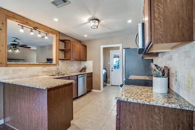 a view of washer and dryer with kitchen in the background